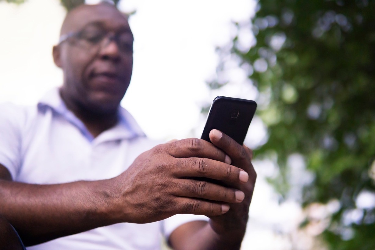 Man holding and loooking at his phone